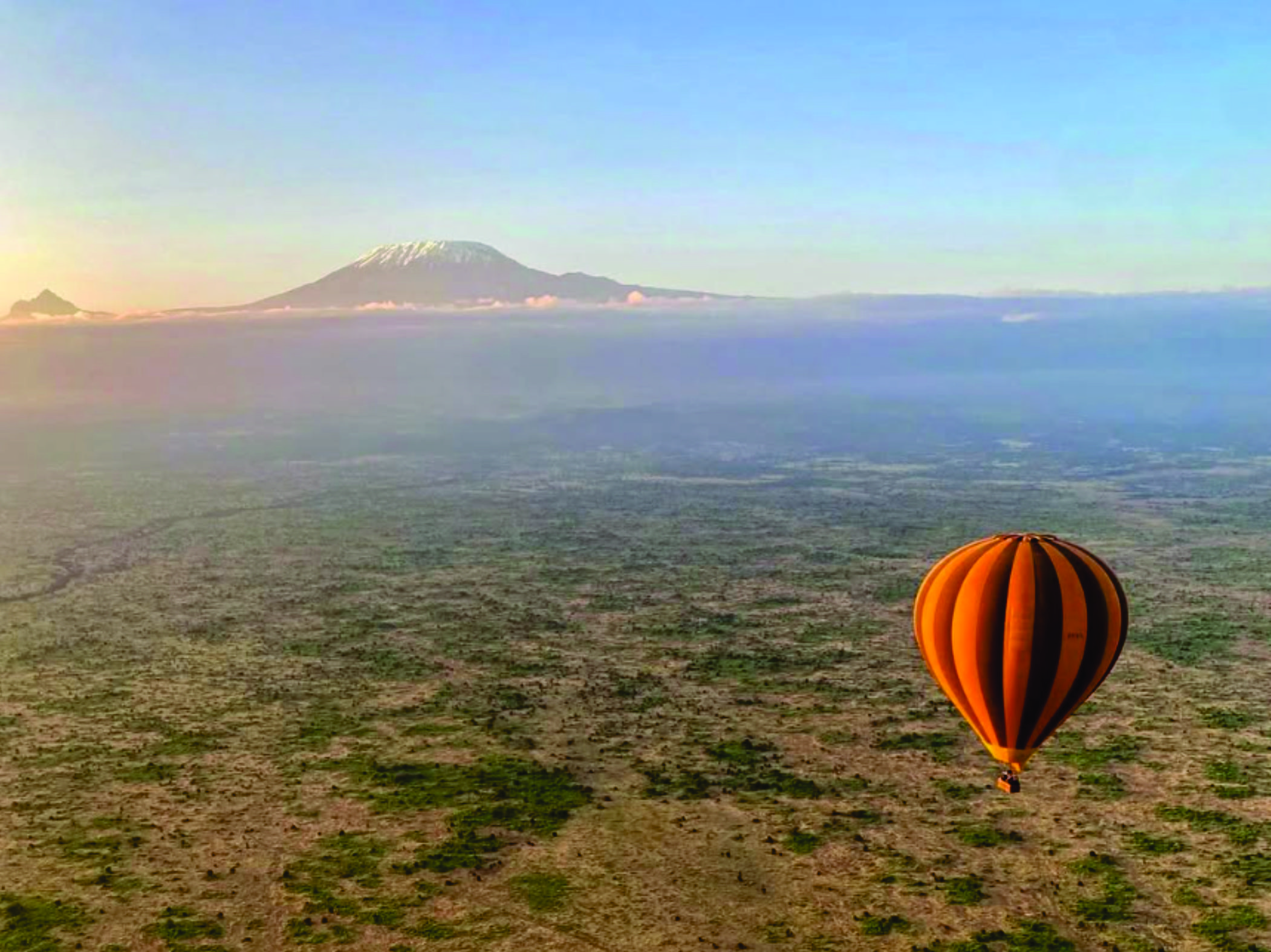 Hot air balloon at sunrise in Amboseli with Mount Kilimanjaro in the distance